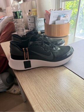 NIKE Black and Gold Low-Top Sneaker
